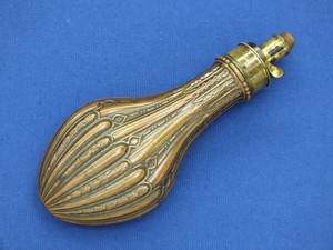 A fine antique 19th Century Embossed English Powder Flask, on the charger signed  