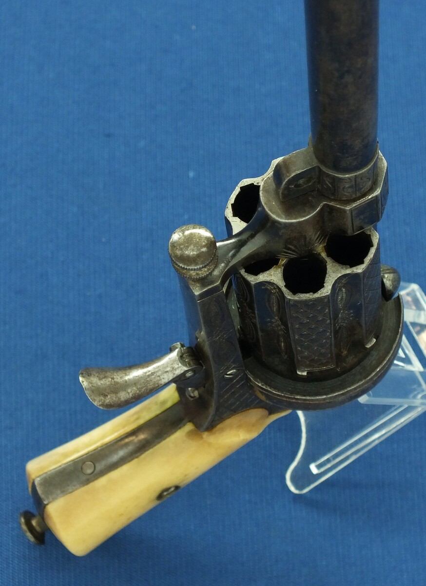 A Fine Antique Belgian engraved 6 shot Pinfire Single and Double Action Pepperbox having a detachable 6 inch barrel. Caliber 9mm. Length 29,5cm. In very good condition. Price 950 euro.