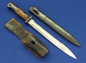 A German WW1 Model 1884/98 Sawback Bayonet with metal scabbard and leather frog. Blade, Pommel and scabbard marked with Crown over 3. Length 40,5cm. In very good condition. Price 450 euro