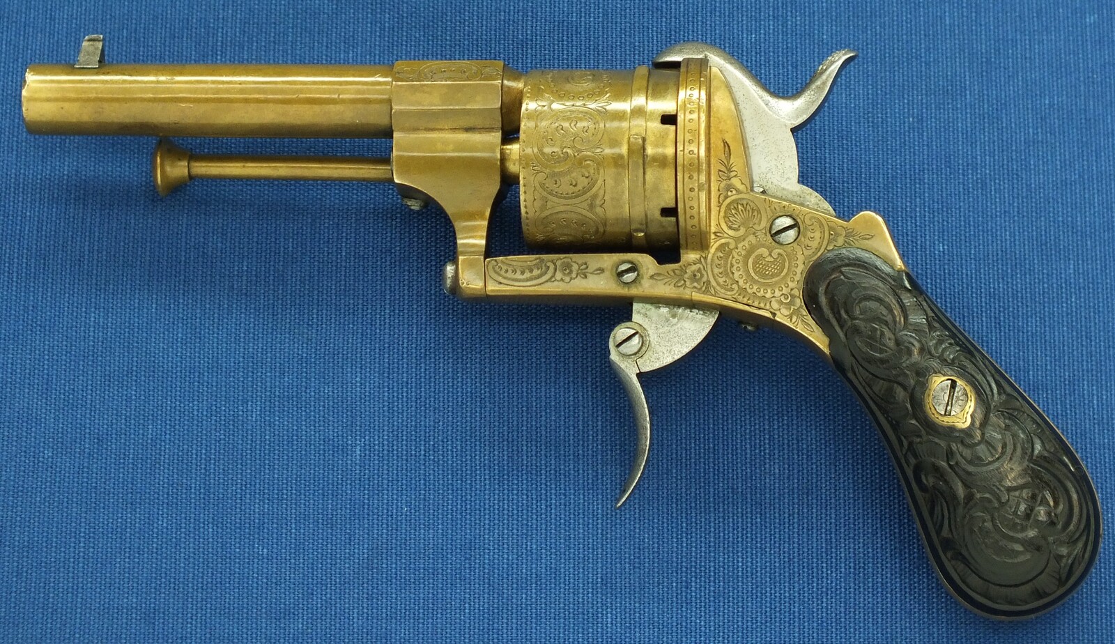 A rare antique Belgian Bronze 6 shot engraved Single and Double Action Pinfire Revolver. Caliber 7mm, length 20cm. In very good condition. Price 775 euro.