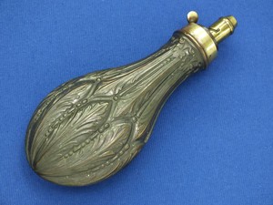 A fine antique 19th Century Embossed English Powder Flask, on the charger signed 