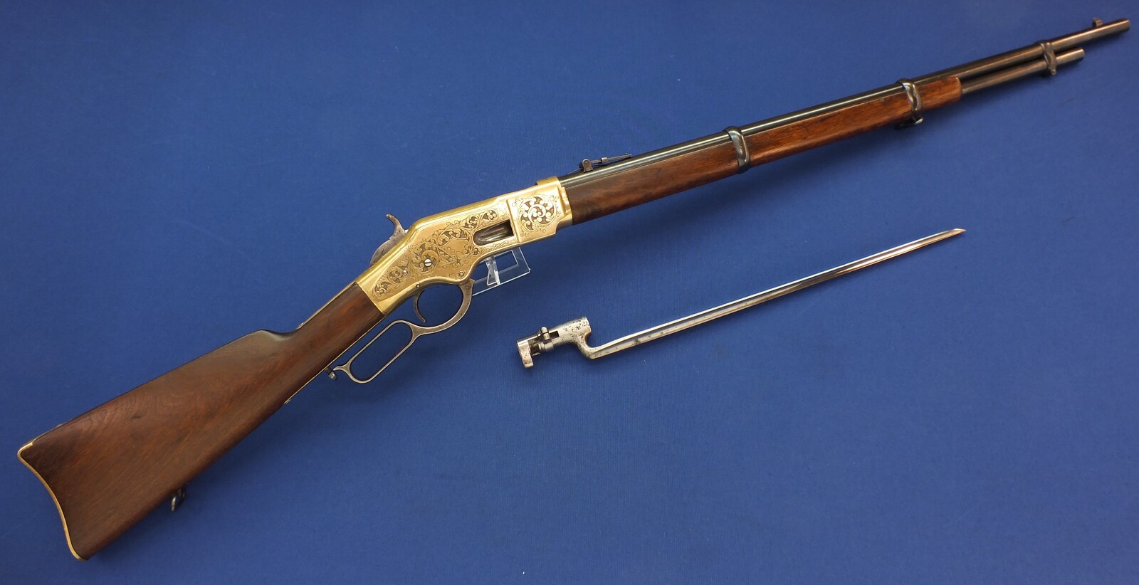 A fine antique American L.D. Nimschke Engraved Winchester Model 1866 Yellow Boy Musket with original Bayonet. 44 Henry Rimfire caliber, 27 inch barrel. Length 118cm. In very good condition. Price on request