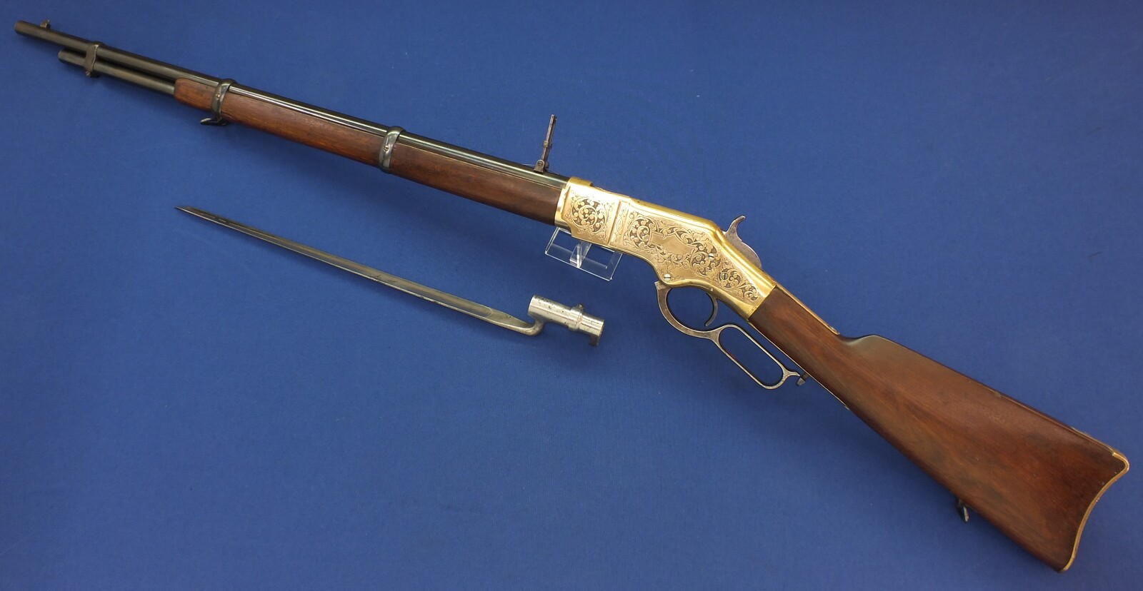 A fine antique American L.D. Nimschke Engraved Winchester Model 1866 Yellow Boy Musket with original Bayonet. 44 Henry Rimfire caliber, 27 inch barrel. Length 118cm. In very good condition. Price on request