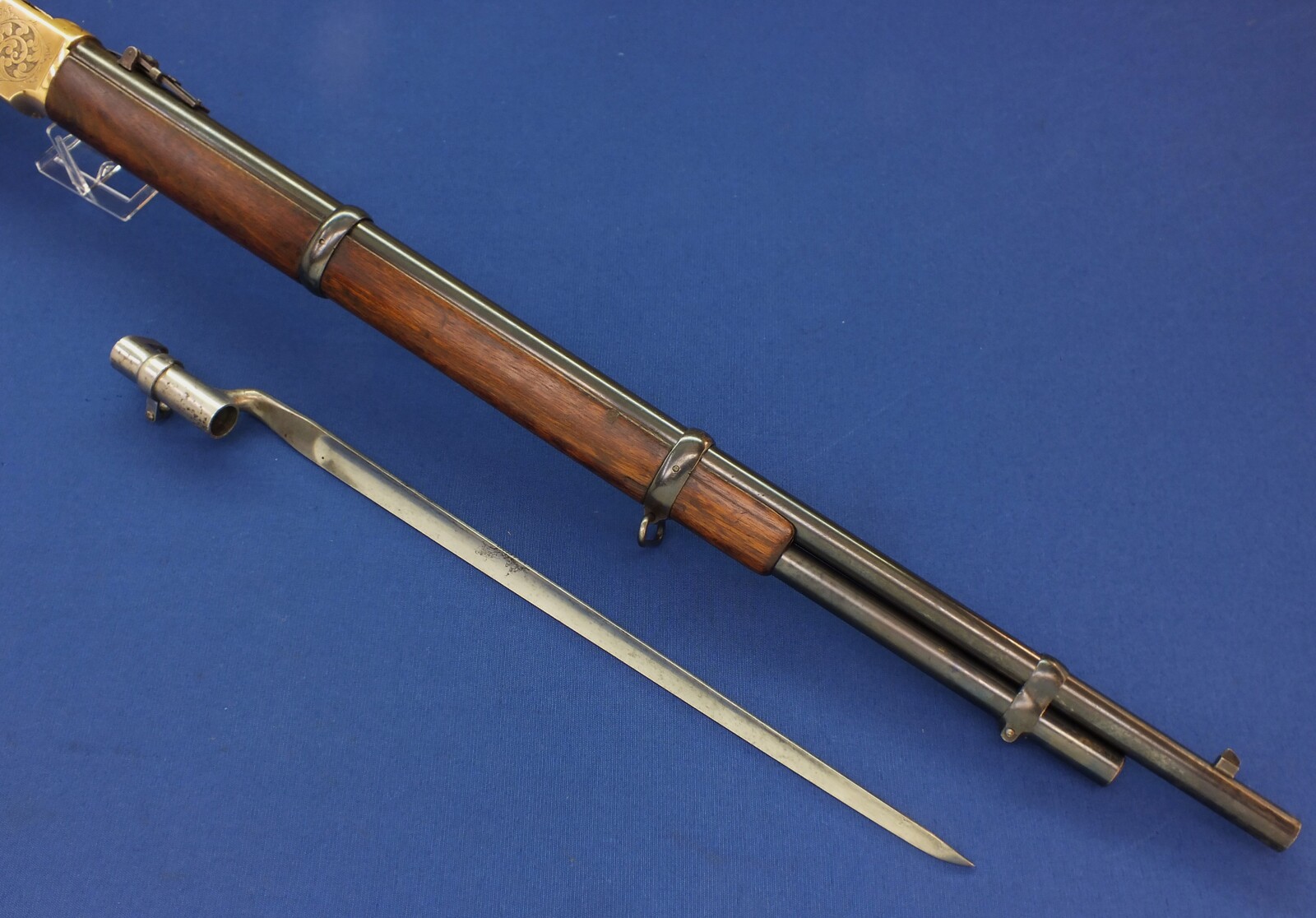 A fine antique American L.D. Nimschke Engraved Winchester Model 1866 Yellow Boy Musket with original Bayonet. 44 Henry Rimfire caliber, 27 inch barrel. Length 118cm. In very good condition. Price on request