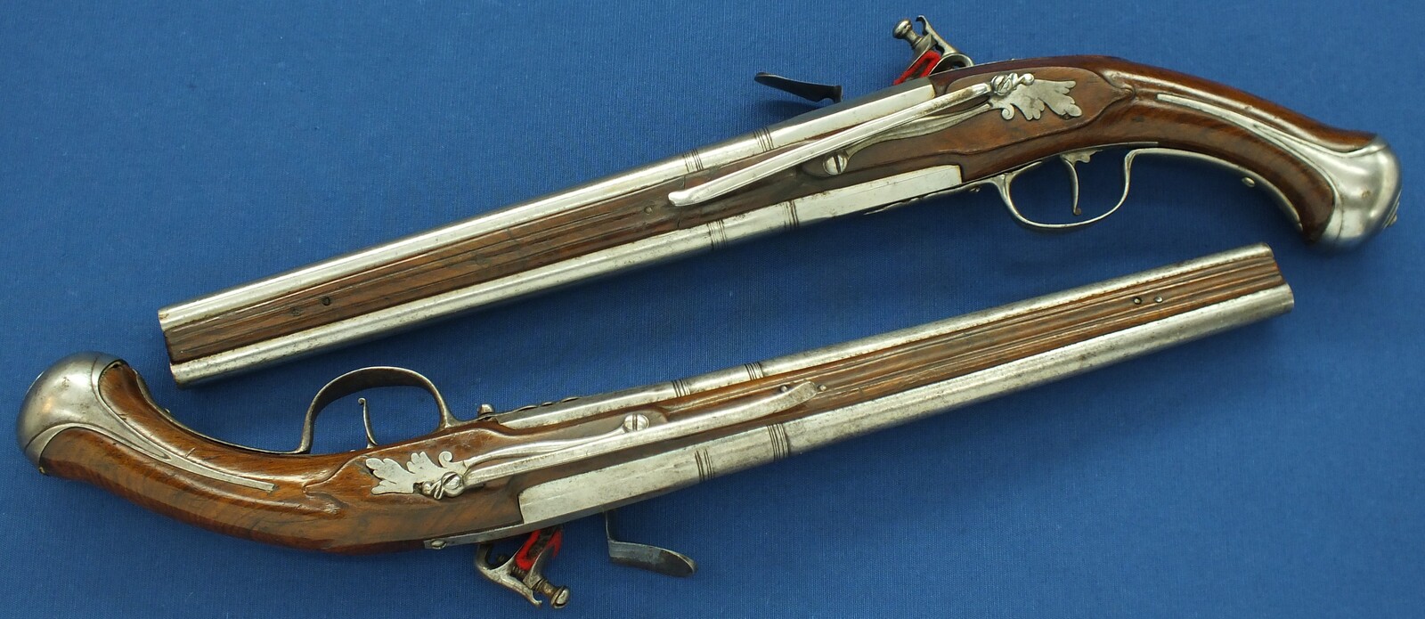 A rare antique Dutch or French 17th century circa 1660-70 Pair of over and under Flintlock pistols with Belt-hooks. Caliber 12mm, length 52. In very good condition. Price 12.500 euro.