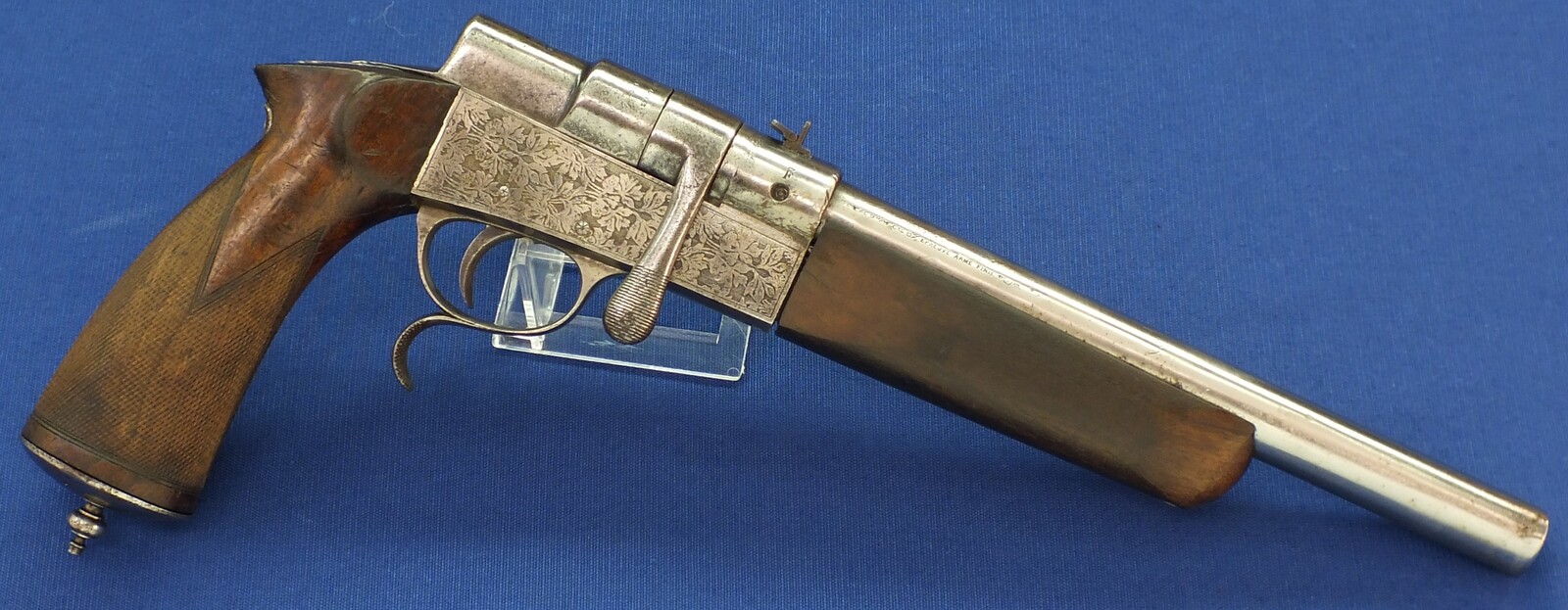 A rare French Buffalo-Stand Euréka bolt action 2 shot caliber 6mm and 9mm Rimfire Flobert Pistol. Length 40cm. In good condition. With original catalogue. Price 695 euro