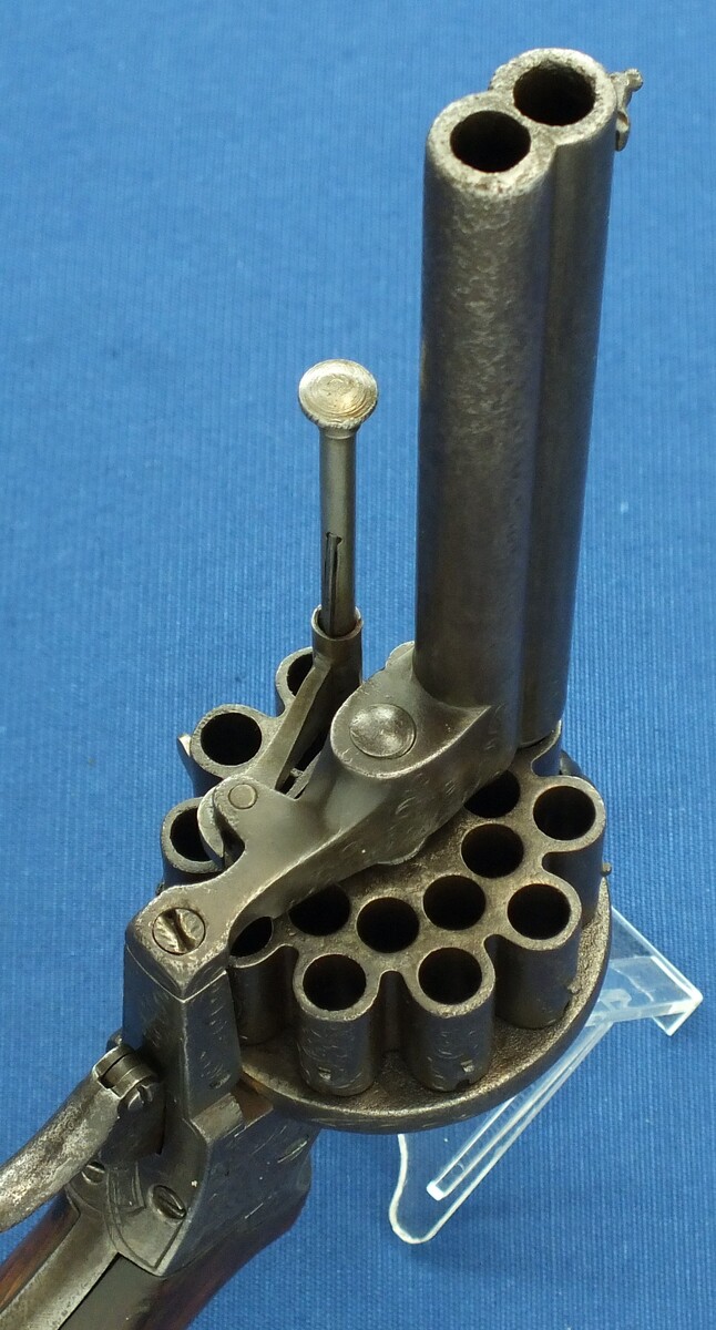 A scarce antique French 20 shot Pinfire Revolver. Signed on barrel: E. Lefaucheux Brevete a Paris. 7mm Caliber, length 27cm. In good/very good condition. Price 1.950 euro.