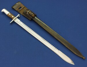 A Swiss Model 1914 Pioneer Bayonet with metal scabbard and leather frog, Made by Waffenfabrik Neuhausen. For Rifle: Schmidt-Rubin Model 1911 Carbine, K31. SN696449. Length 64cm. In very good condition. Price 375 euro