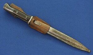 A WW2 German K98 Mauser Bayonet made by Gebruders Heller 1940 with original leather Frog and matching numbered 6079 scabbard. Length 40cm. In very good condition.