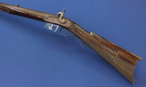 An antique American Left handed Kentucky/Plains percussion rifle. 52 Caliber, 38 inch octagon barrel signed G/Gatts. Fine Tiger-striped Walnut stock. Length 138cm. In very good condition.