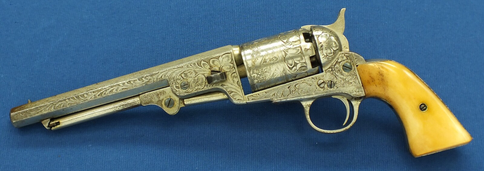 An antique Belgian Brevete engraved and Nickel Plated Colt Model 1851 Navy 6 shot Percussion Revolver by Jean-Baptiste Rongé & Fils. Caliber 35, 7 inch barrel. Length 34,5cm. In very good condition. Price 1.750 euro.