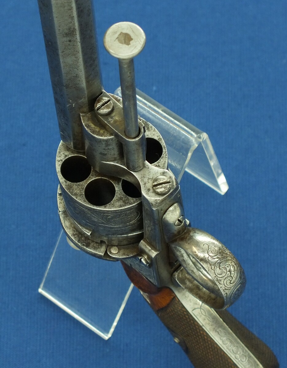 An antique Belgian/Liege engraved Lefaucheux type 6 shot single and Double-Action 12mm pinfire Revolver with rare swing out ejector Rod fixed in frame. Length 31,5cm. In good/very good condition. Price 750 euro