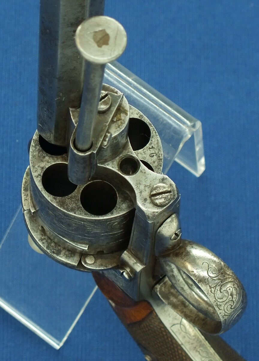 An antique Belgian/Liege engraved Lefaucheux type 6 shot single and Double-Action 12mm pinfire Revolver with rare swing out ejector Rod fixed in frame. Length 31,5cm. In good/very good condition. Price 750 euro
