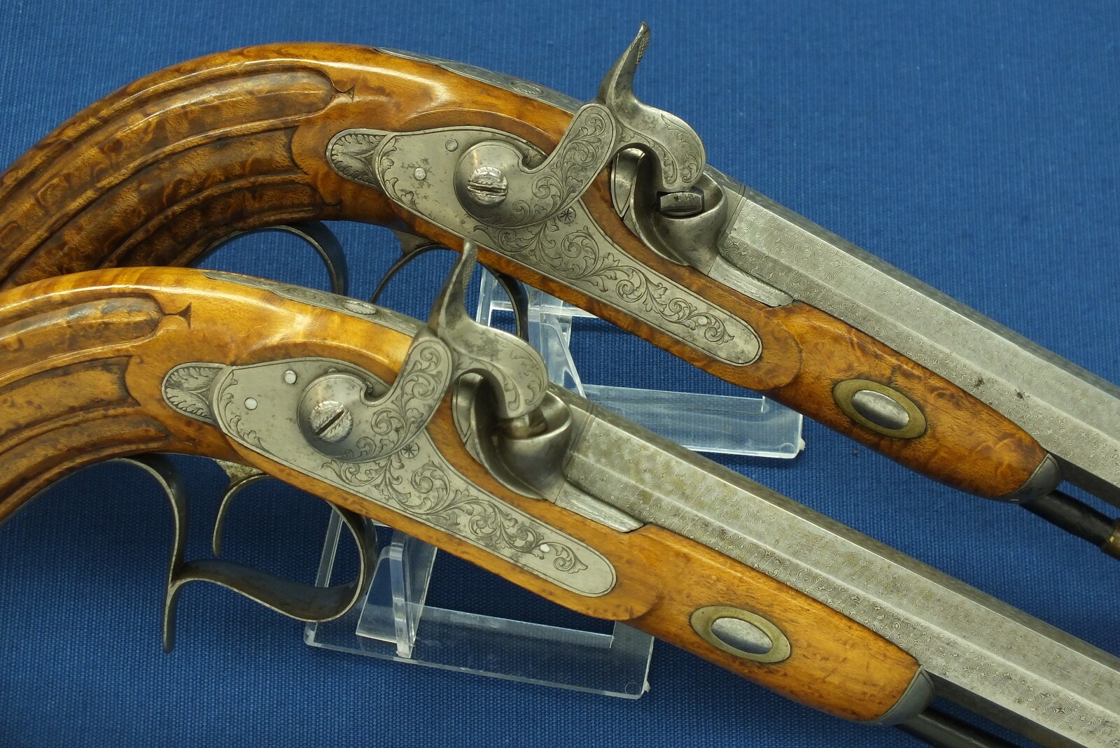 An antique cased pair of Belgian Liege Percussion pistols with Damast barrels. 13mm Caliber, length 34cm. In very good condition. Price 7.500 euro