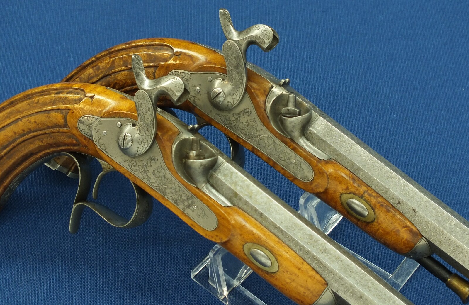 An antique cased pair of Belgian Liege Percussion pistols with Damast barrels. 13mm Caliber, length 34cm. In very good condition. Price 7.500 euro