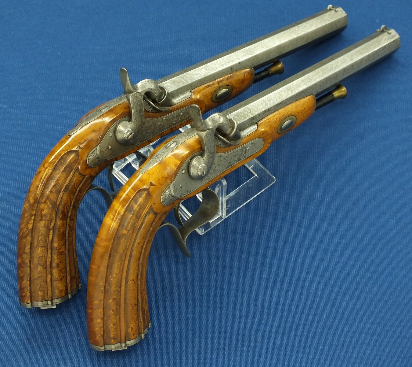 An antique cased pair of Belgian Liege Percussion pistols with Damast barrels. 13mm Caliber, length 34cm. In very good condition. Price 7.500 euro