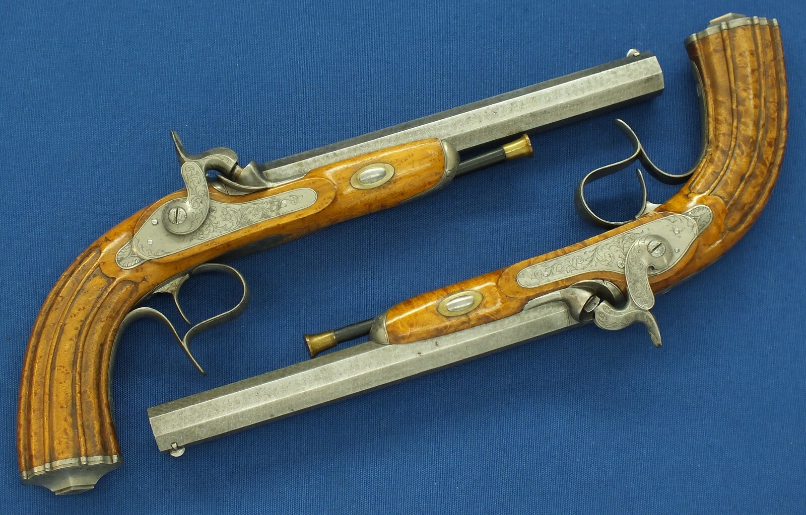 An antique cased pair of Belgian Liege Percussion pistols with Damast barrels. 13mm Caliber, length 34cm. In very good condition. Price 7.500 euro