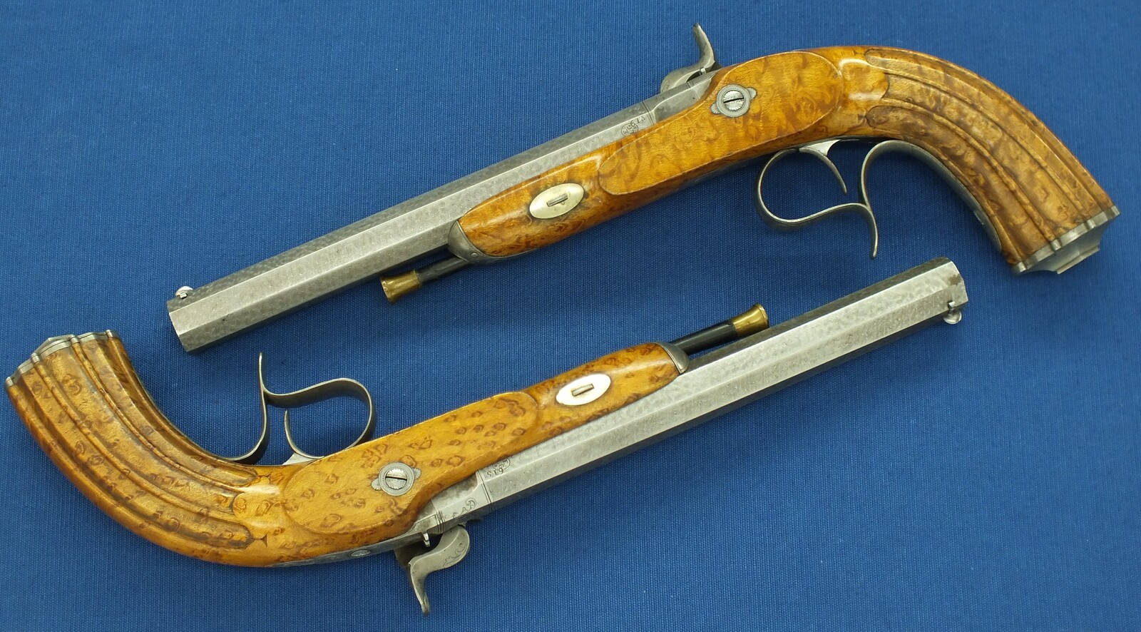 An antique cased pair of Belgian Liege Percussion pistols with Damast barrels. 13mm Caliber, length 34cm. In very good condition. Price 7.500 euro