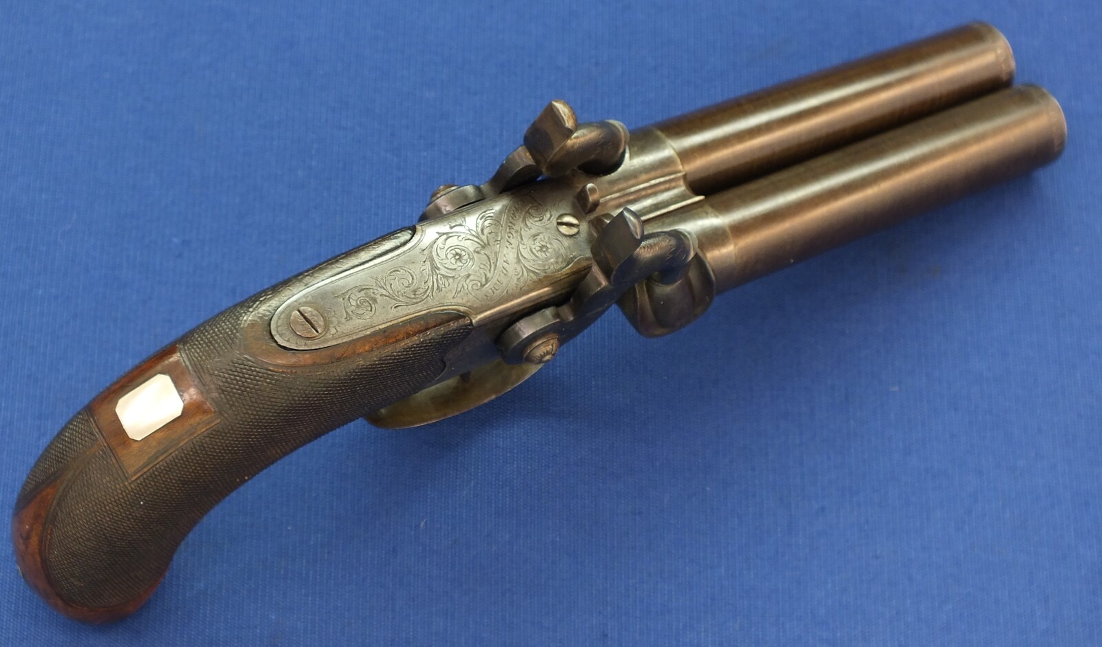 An antique English 19th century circa 1850 Box-Lock percussion double barreled pistol. By George Adams. Caliber 12mm. Length 25,5cm. In very good condition. Price 950 euro.