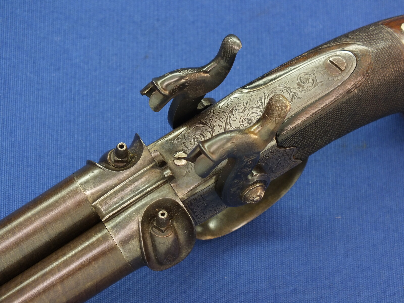 An antique English 19th century circa 1850 Box-Lock percussion double barreled pistol. By George Adams. Caliber 12mm. Length 25,5cm. In very good condition. Price 950 euro.