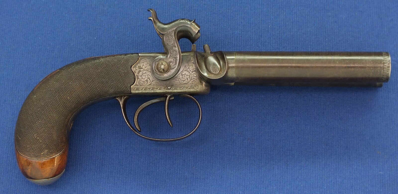 An antique English 19th century circa 1850 Box-Lock percussion double barreled pistol. By George Adams. Caliber 12mm. Length 25,5cm. In very good condition. Price 950 euro.