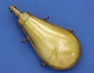 An antique probably German green Horn Powderflask with a spring-pump charger, circa 1800. Height 18,5 cm. In very good condition. Price 375 euro